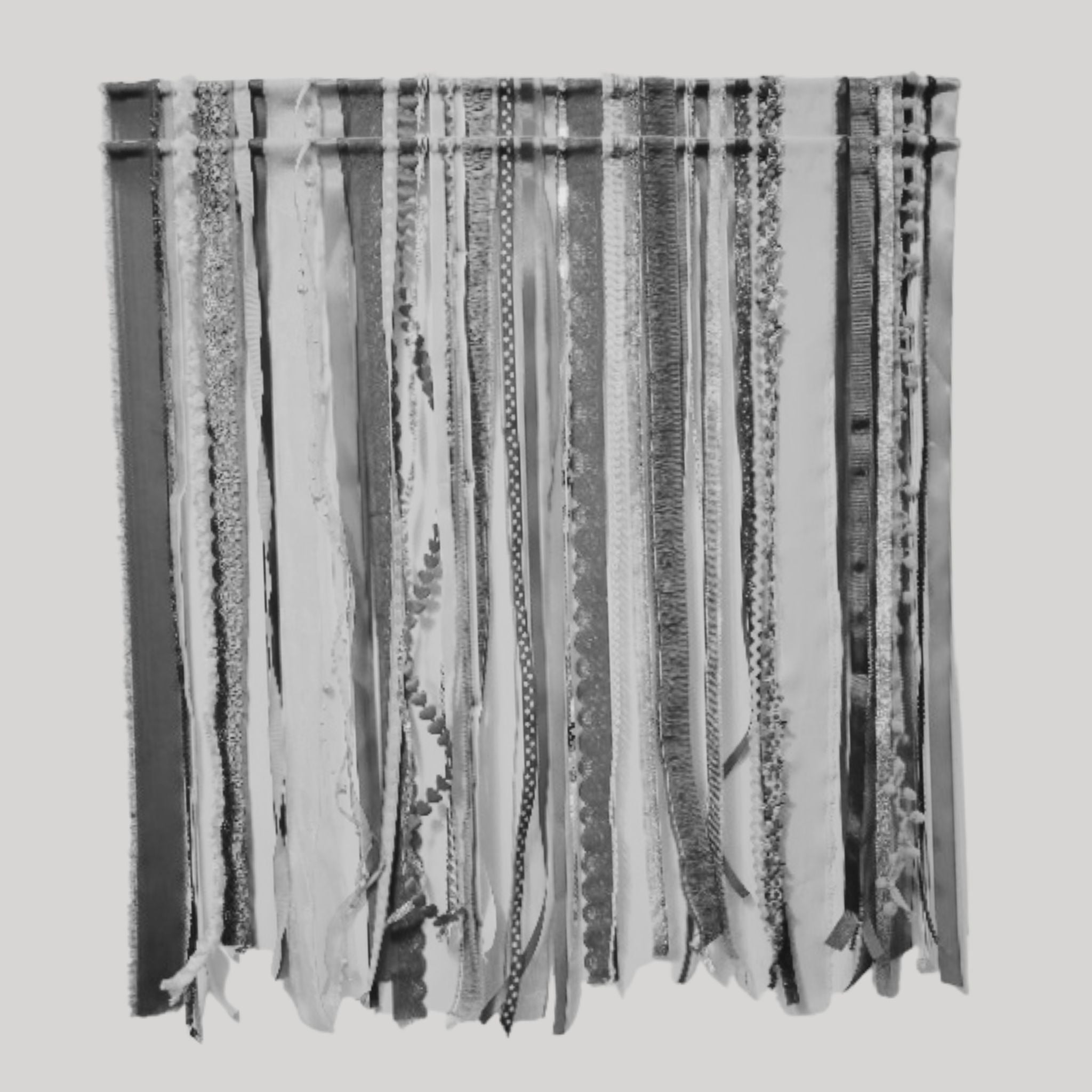 gray and white tiered ribbon wall hanging