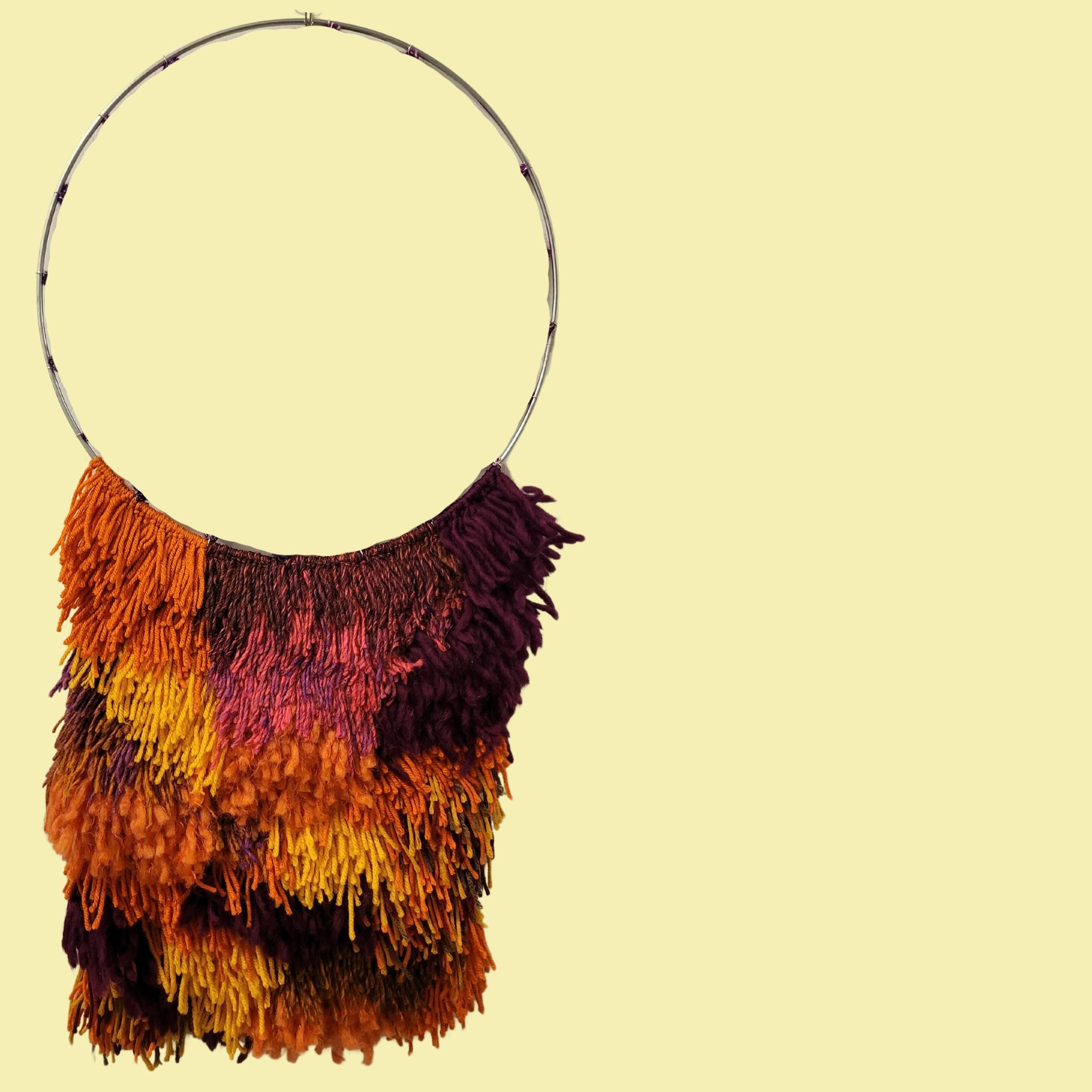 metal hoop wall hanging with fall colored yarn