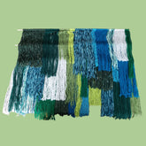 green and blue  tiered yarn wall hanging