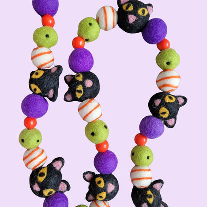 hand-crafted black cats on a Halloween garland