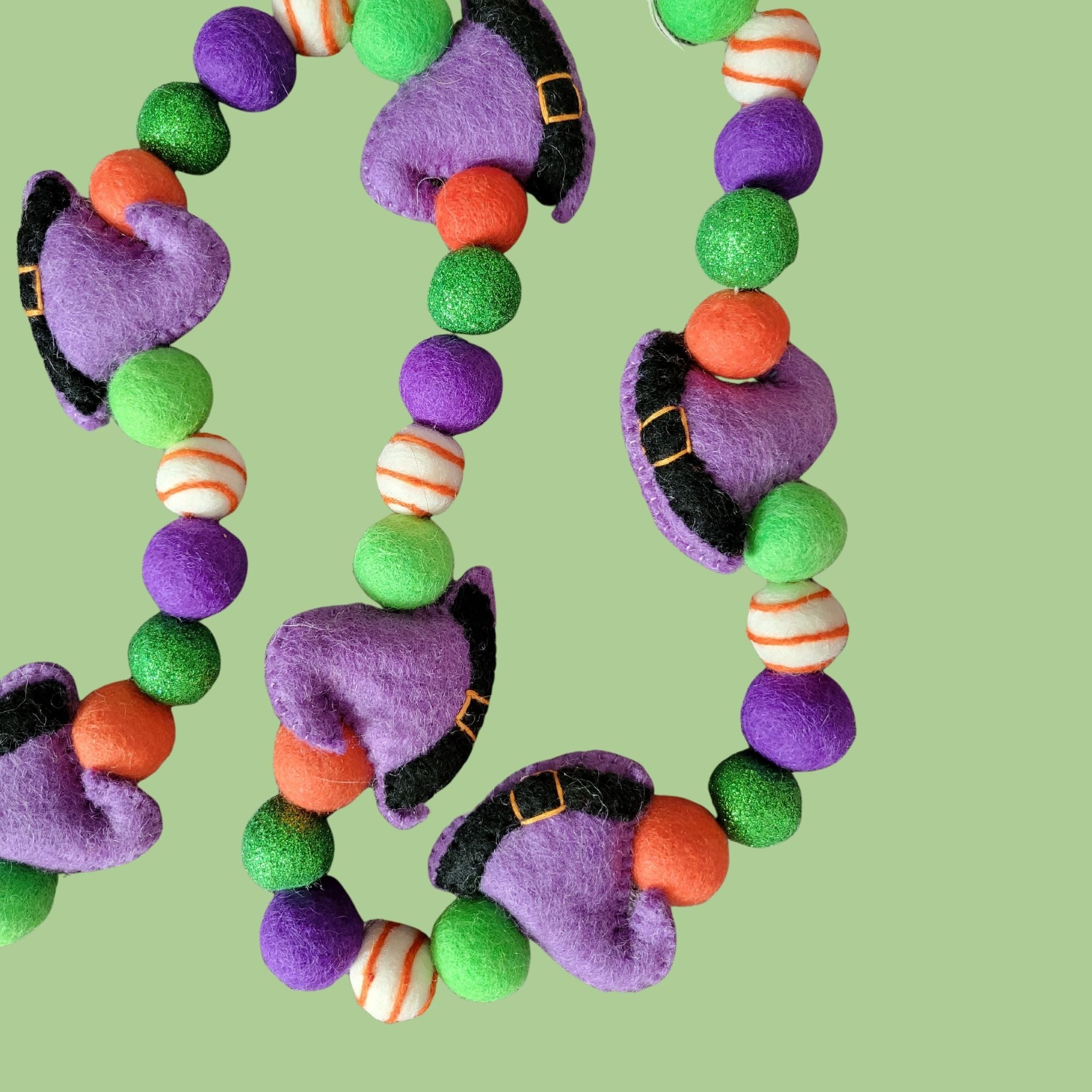 hand-crafted Halloween garland with purple witches hats